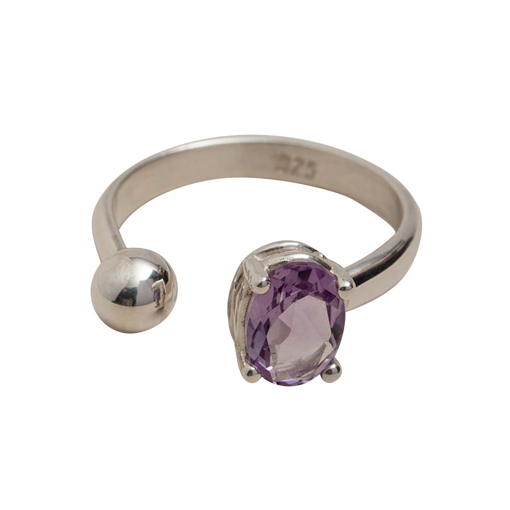 Silver ring with a purple gemstone on a white background