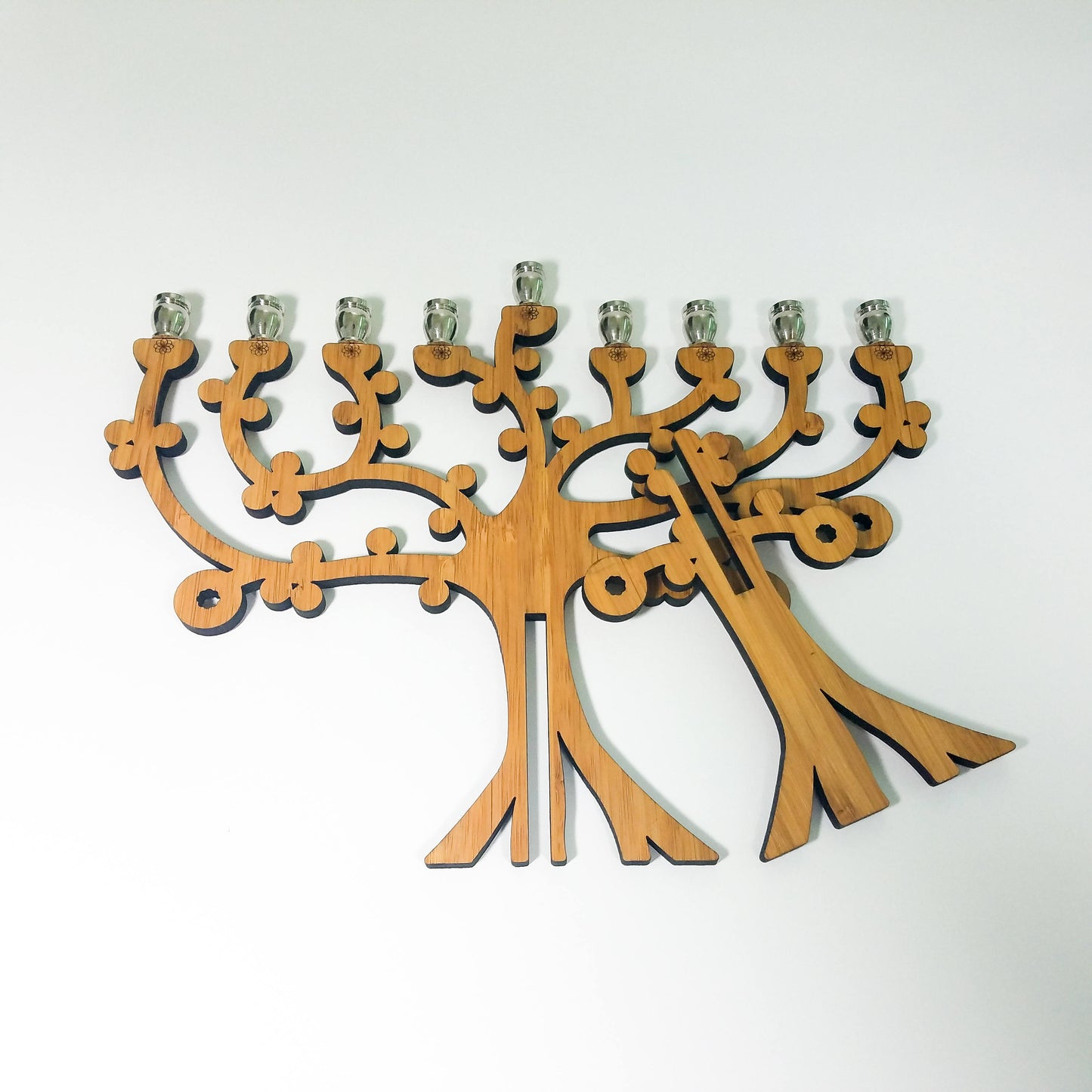 Wooden menorah with a tree design on a white background