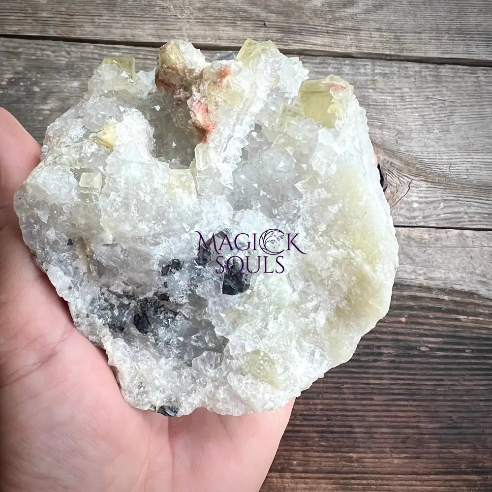 Large fluorite crystal rock held in a hand.