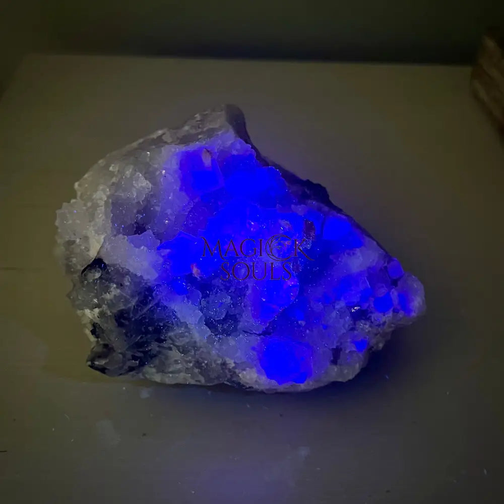 Fluorite crystal rock with blue glow on a dark background