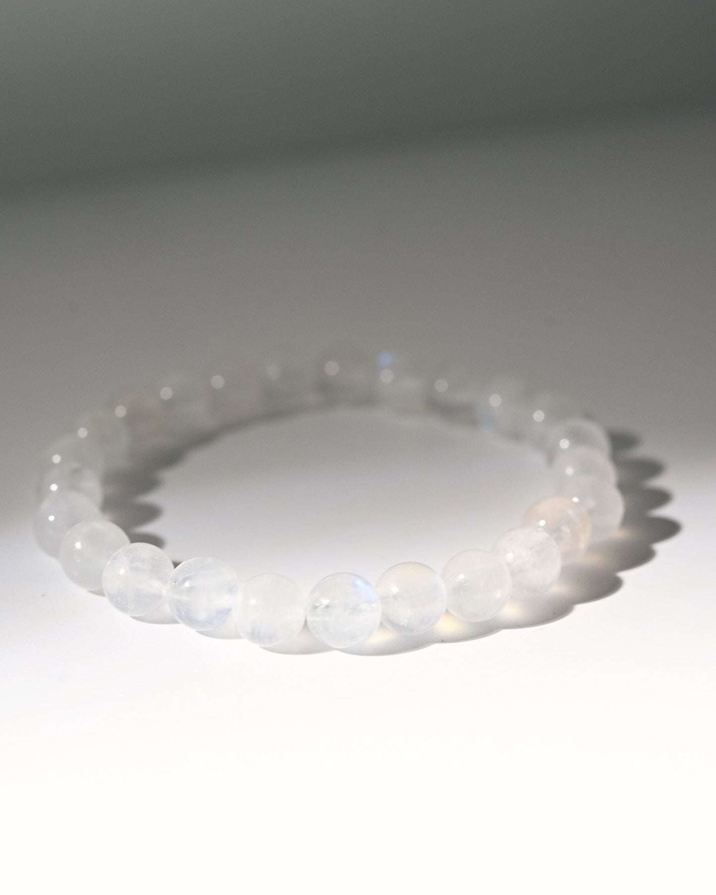 Bracelet white stones on a light gray background