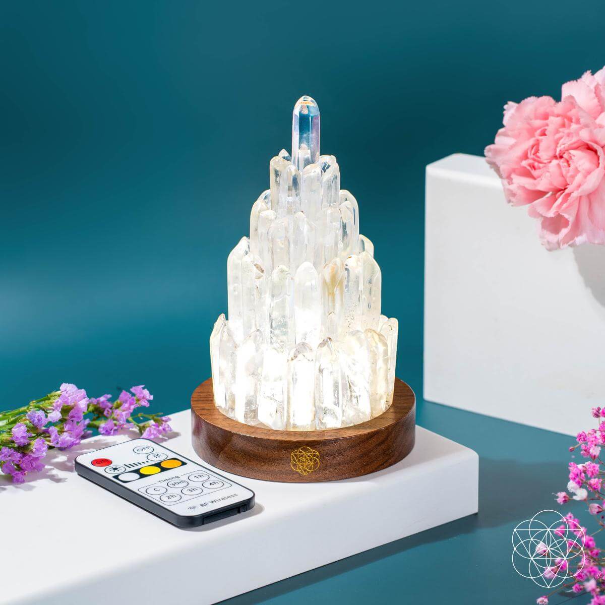 Crystal lamp with remote control on a white surface with flowers