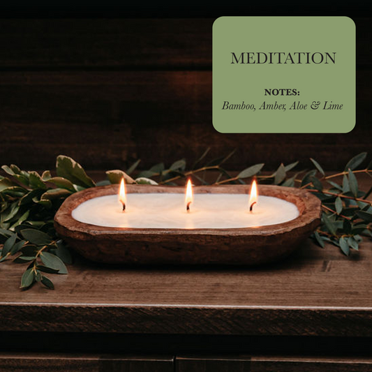 Three candles in a wooden holder with green leaves on a dark background, labeled 'Meditation' with notes.