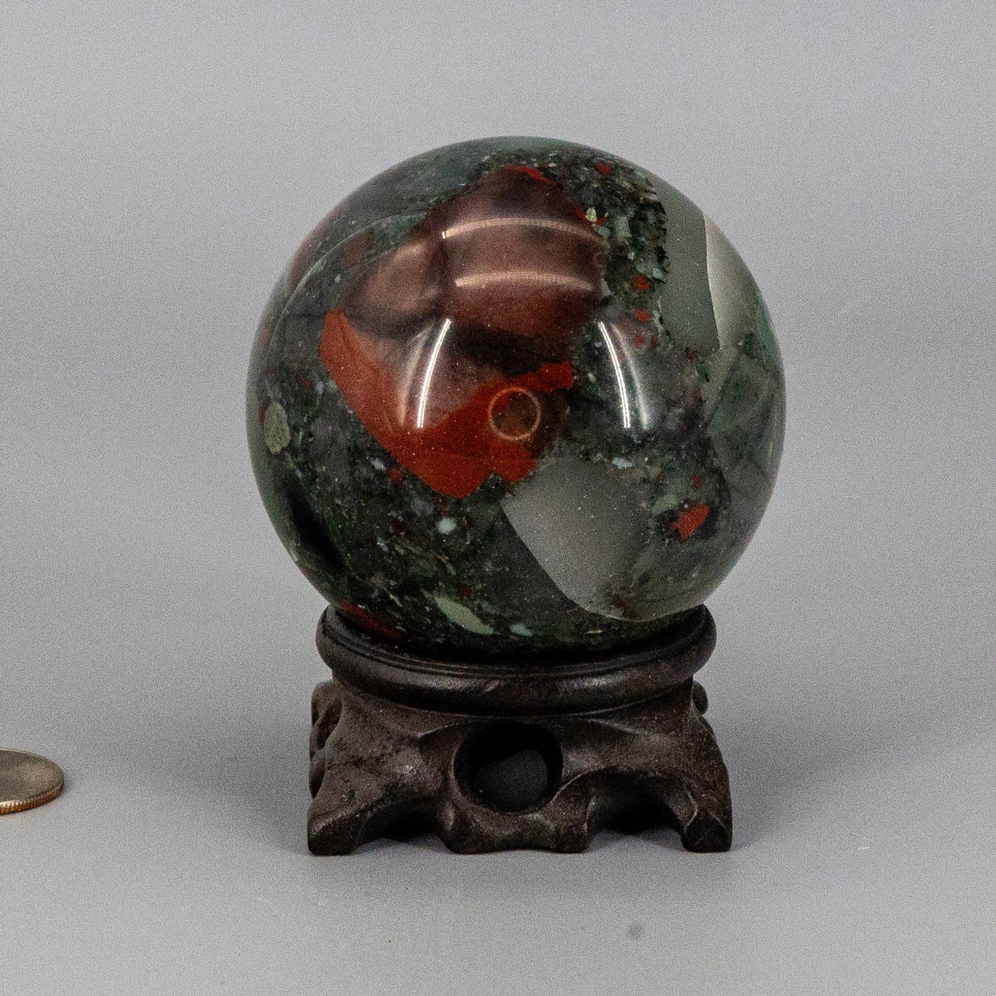Decorative bloodstone sphere on a gray background
