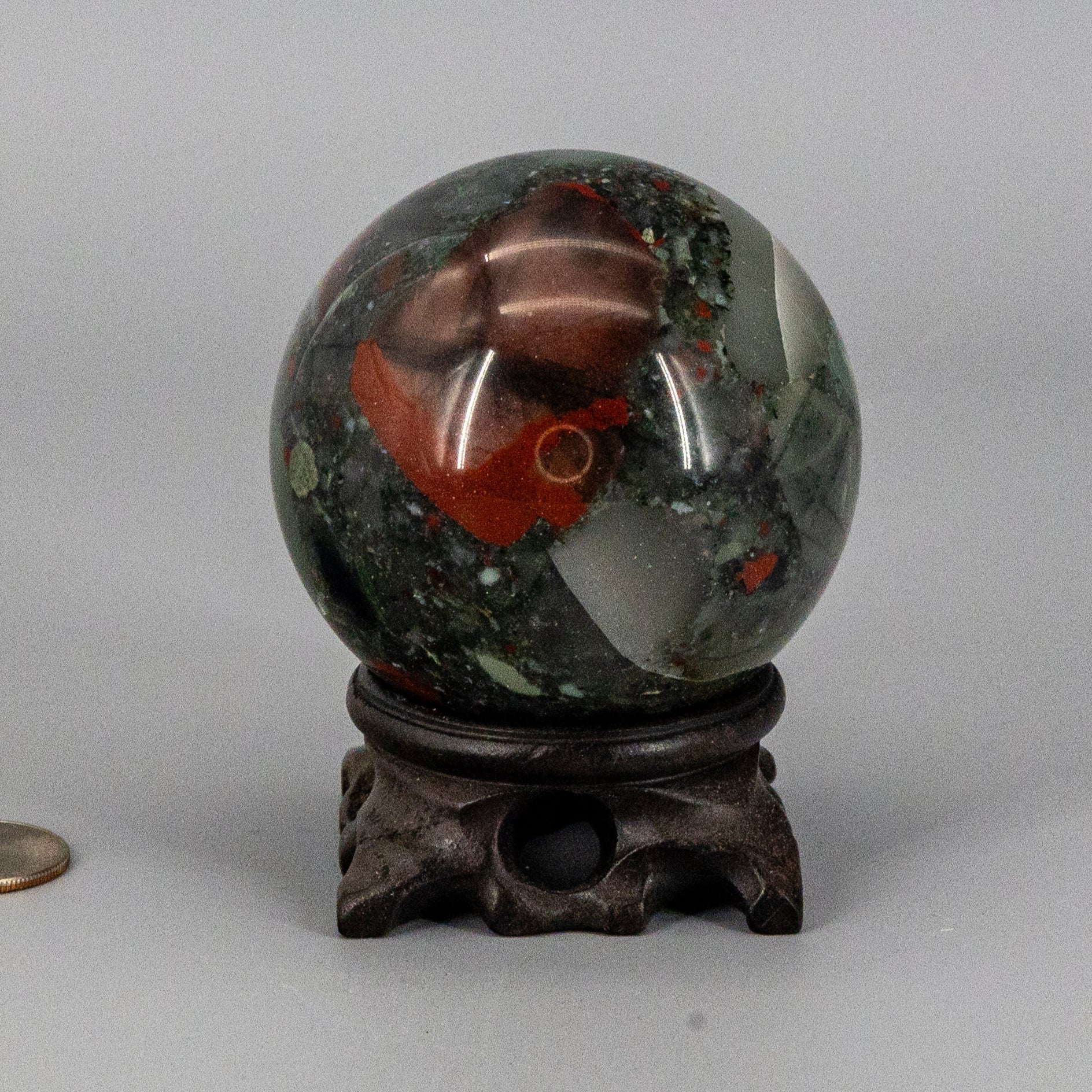 Decorative bloodstone sphere on a gray background