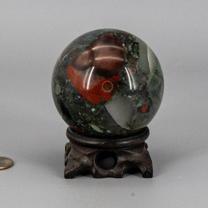 Decorative bloodstone sphere on a gray background