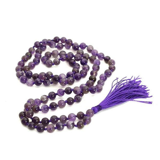 Purple beaded necklace with a tassel on a white background