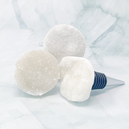 Wine bottle stopper with white stone on a light blue background
