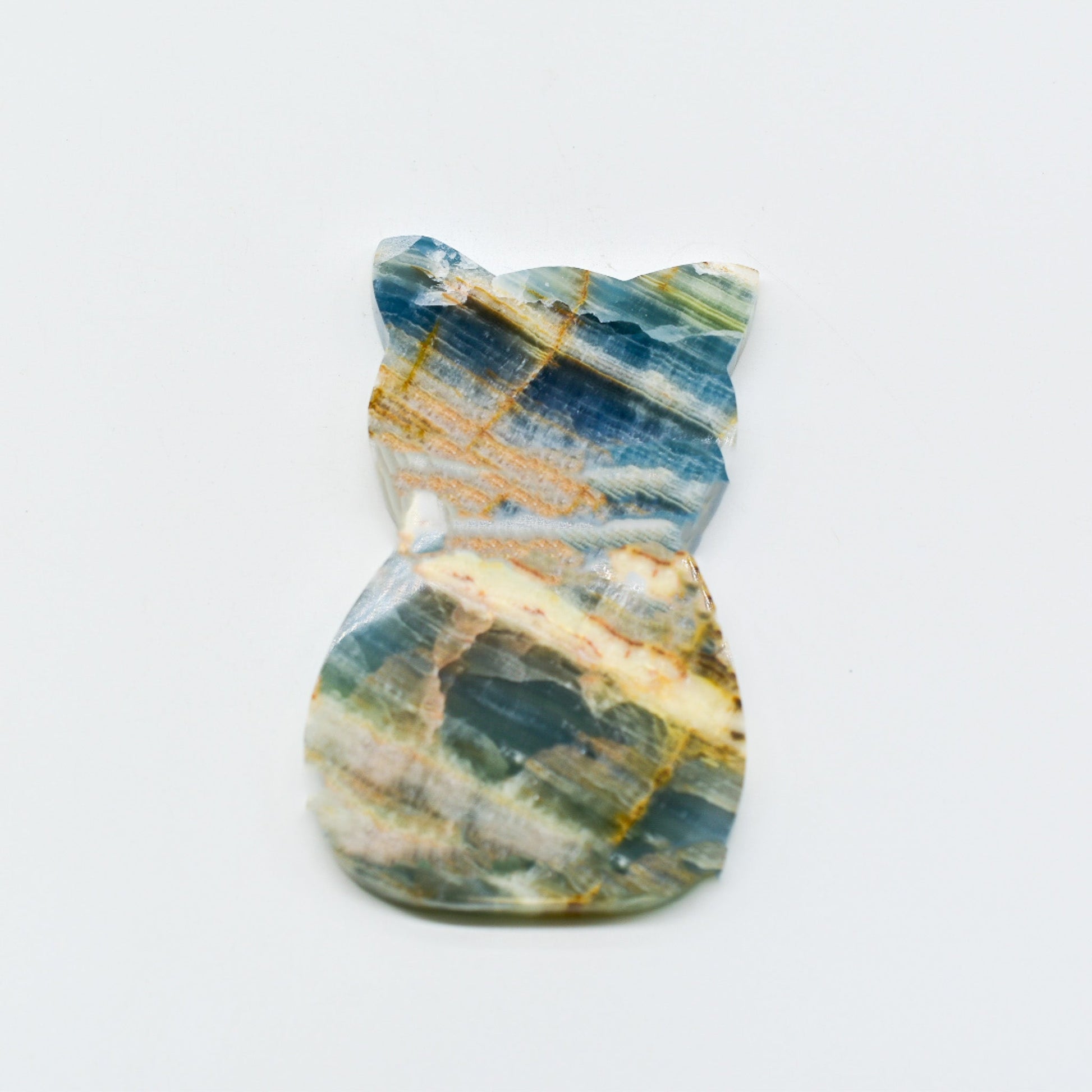 Polished blue onyx with blue, green, and gold patterns on a white background