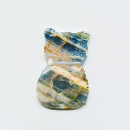 Polished blue onyx with blue, green, and gold patterns on a white background