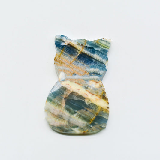 Polished blue onyx with blue, green, and gold patterns on a white background