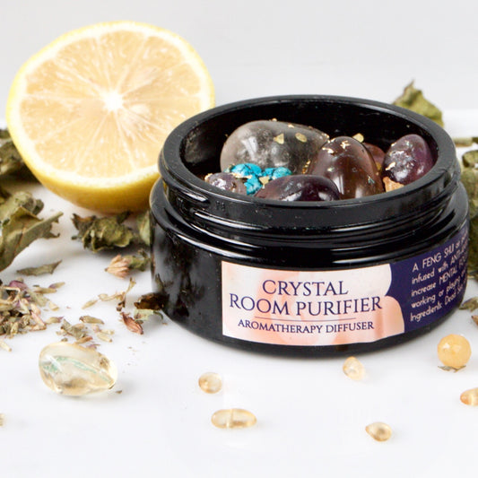 Crystal room purifier with lemon and herbs on a white background