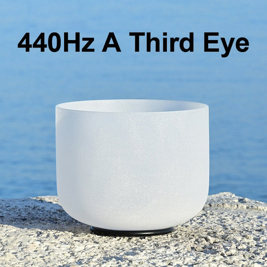White crystal singing bowl with text '440Hz A Third Eye' against a blue water background