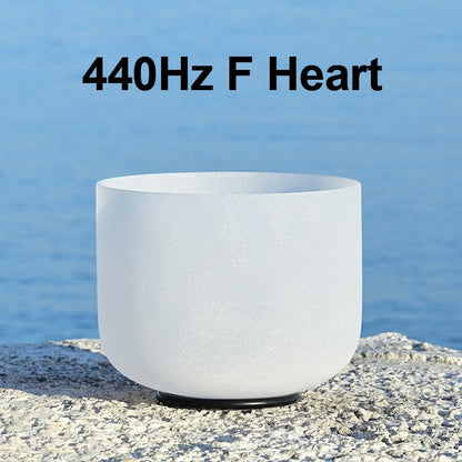 White singing bowl with '440Hz F Heart' text against a blue water background