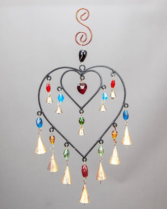 Decorative hanging heart-shaped ornament with colorful beads on a gray background
