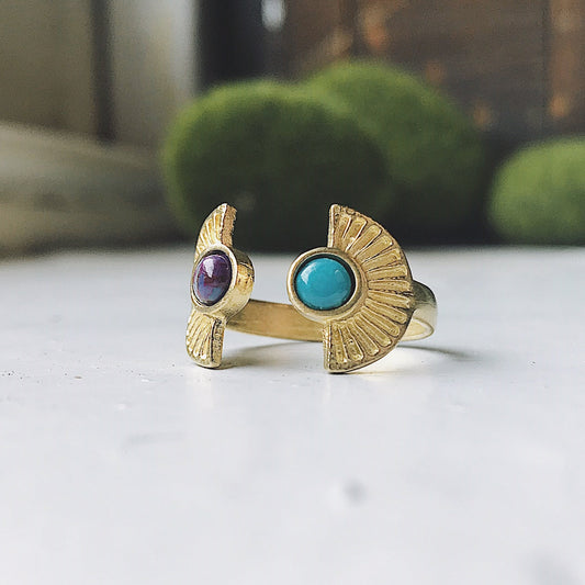 Gold rings with gemstones on a white surface