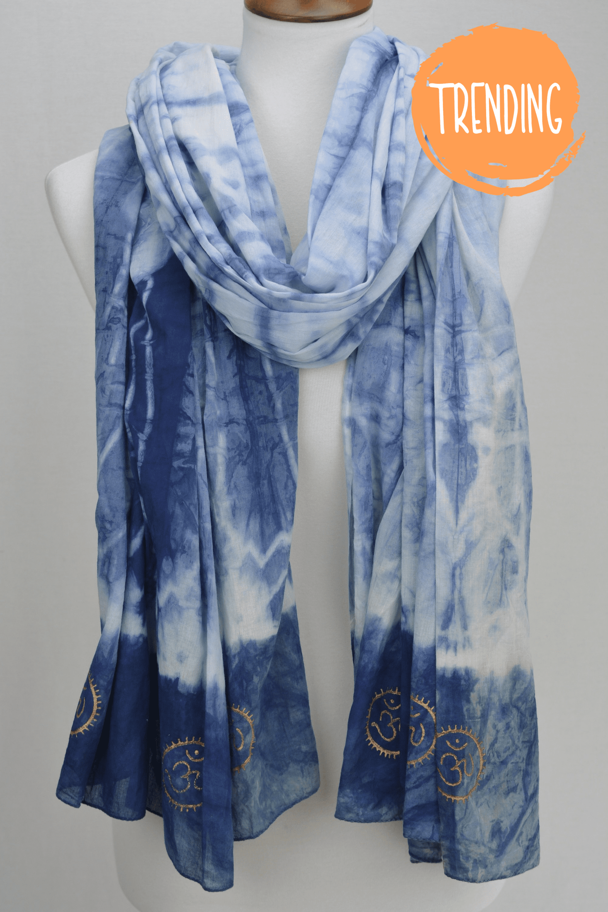 Blue tie-dye scarf on a mannequin with 'Trending' label.