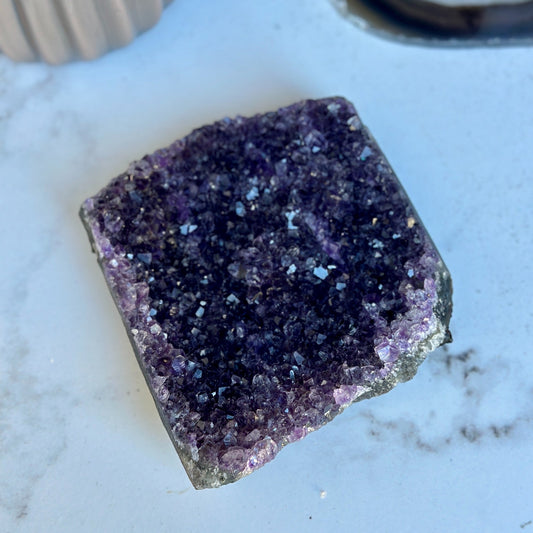 Flat amethyst crystal cluster