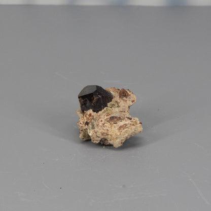 Garnet raw cluster on a gray background