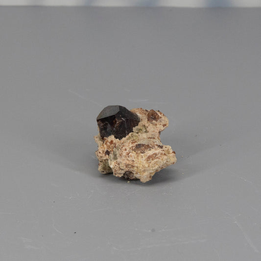 Garnet raw cluster on a gray background
