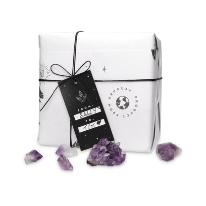 Gift box with purple crystals on a white background