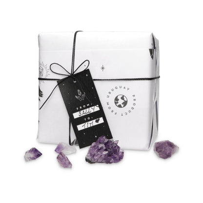Gift box with purple crystals on a white background