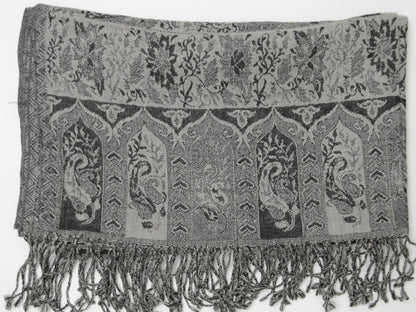Textured shawl with paisley patterns and fringes on a white background