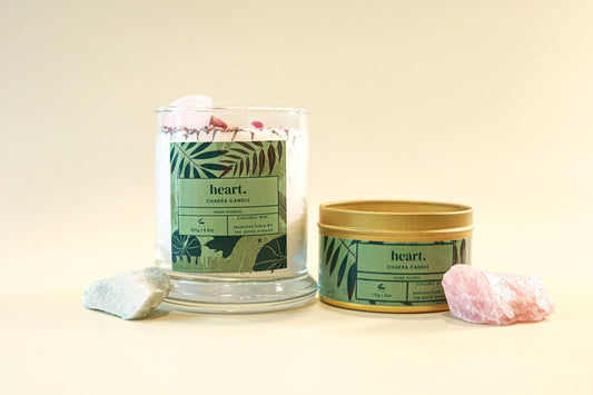 Two candles with 'heart.' branding on a beige background