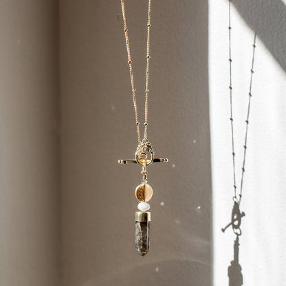 Labradorite lariat necklace with a pendant on a neutral background