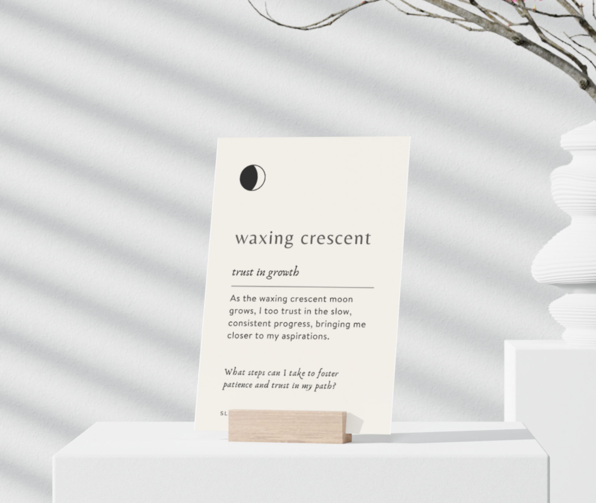 Card with text about the waxing crescent moon phase on a white surface