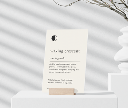 Card with text about the waxing crescent moon phase on a white surface