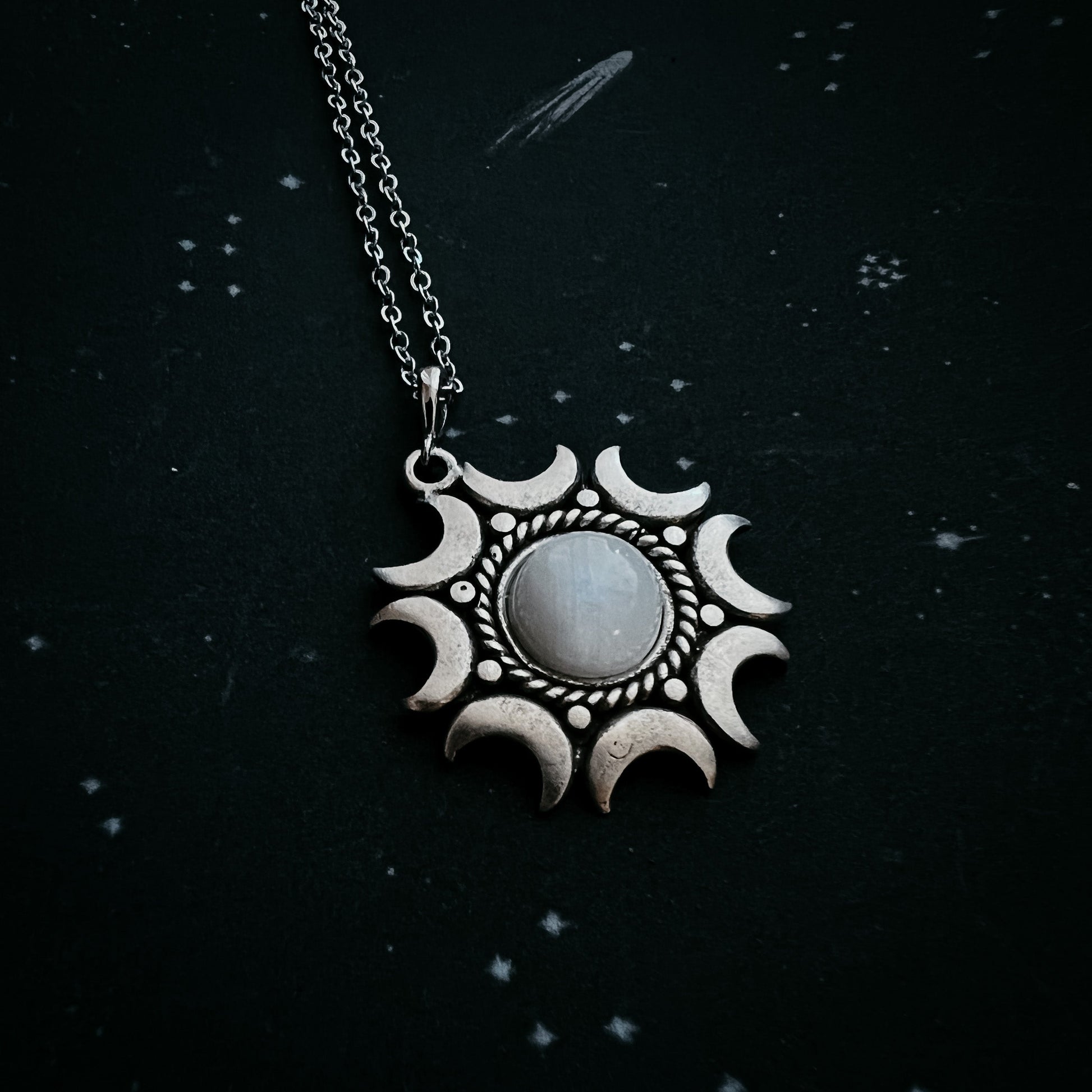 Necklace with a moonstone pendant on a dark background