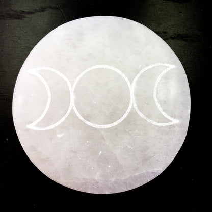 Crystal with triple moon symbol on a dark background