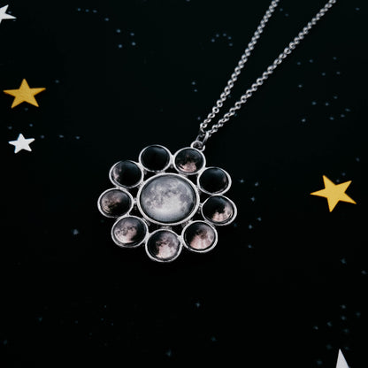 Necklace with a circular pendant featuring moon phases on a starry night background