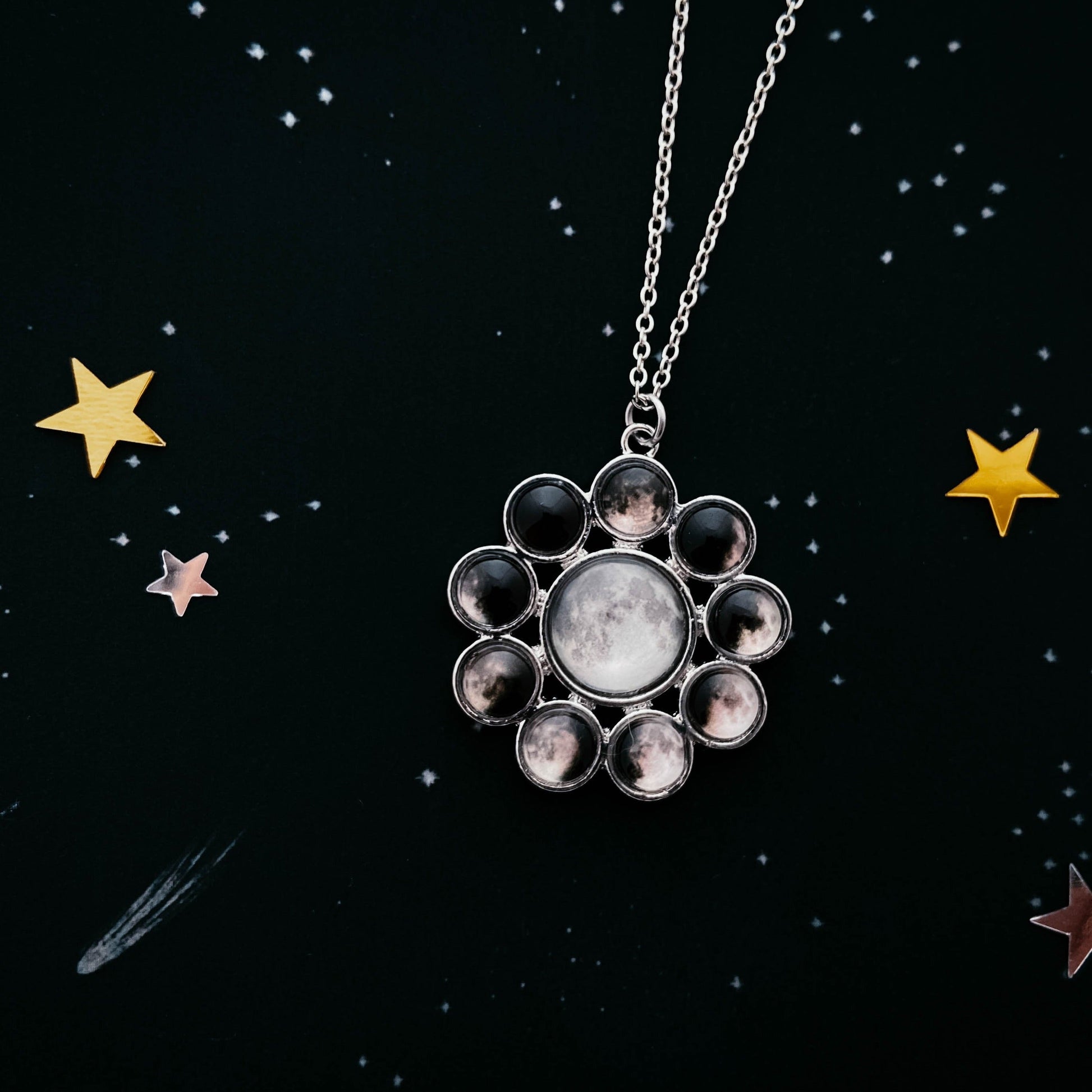 Necklace with a star-shaped pendant on a black background with stars