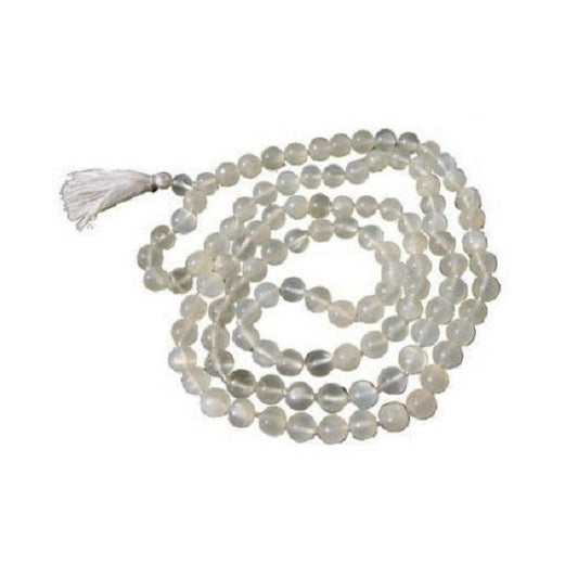 String of moonstone beads with a tassel on a white background