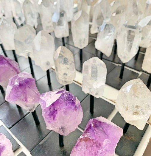 Close-up of purple and clear crystal rocks on a grid background