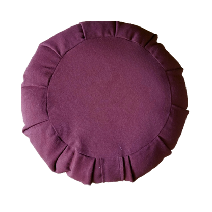 Round burgundy cushion with pleated edges on a white background
