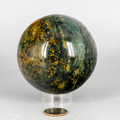 Decorative ocean jasper sphere with green and brown patterns on a white background