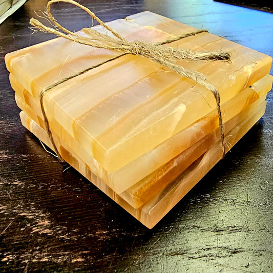 Stack of coasters tied with twine on a wooden surface