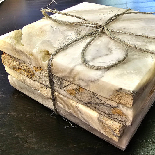 Marble-patterned stone with twine tied around it on a dark surface