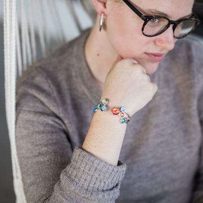 Person wearing a colorful bracelet on a blurred background