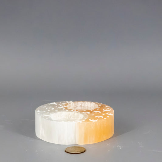 Decorative Yin-Yang selenite tea light candle holders on a gray background