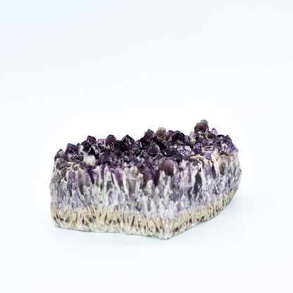 Amethyst crystal cake on a white background