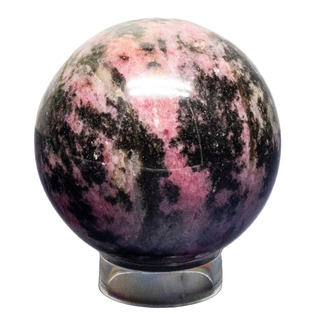 Polished rhodonite sphere on a white background