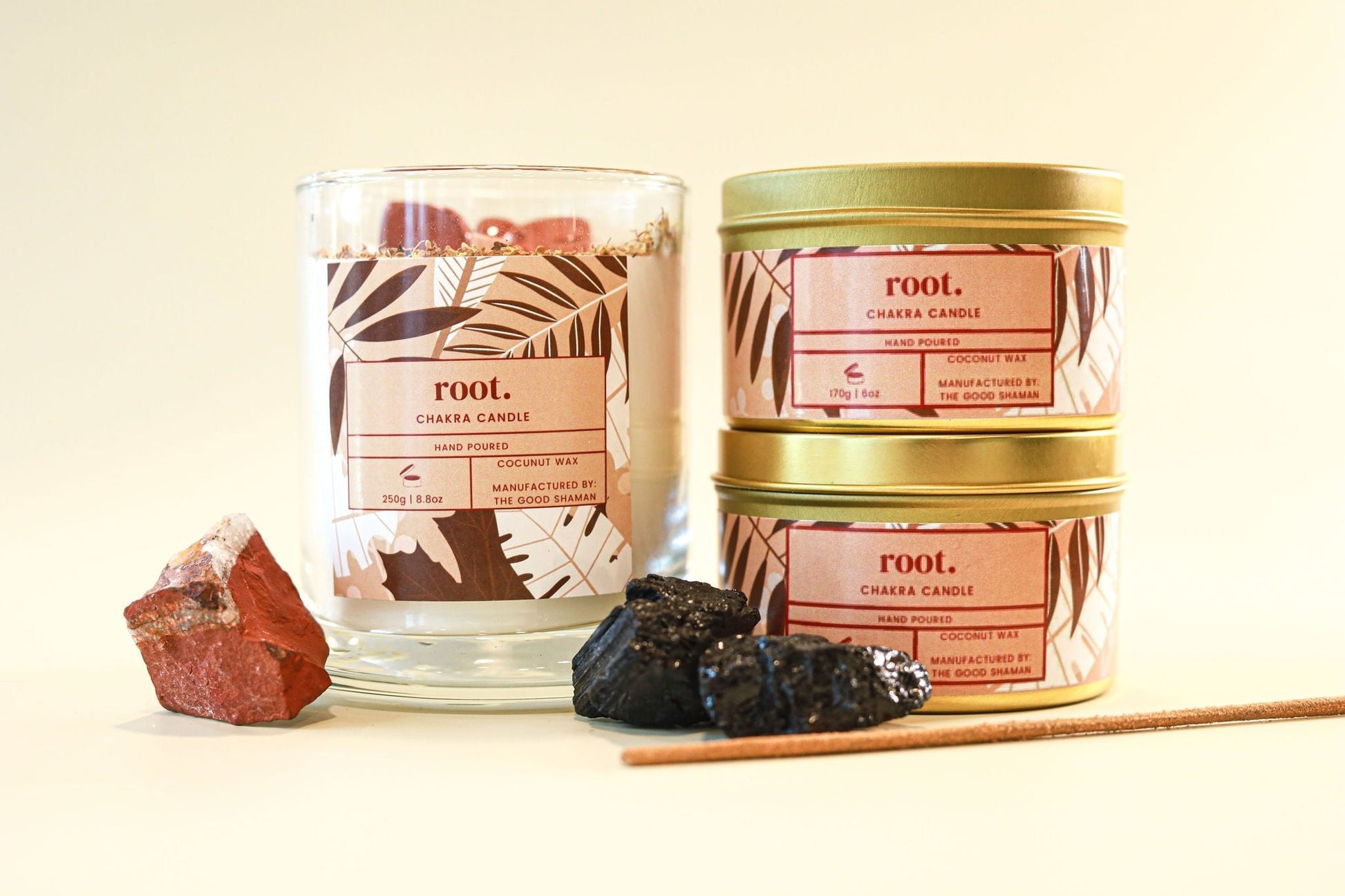 Root chakra candles with decorative elements on a light background