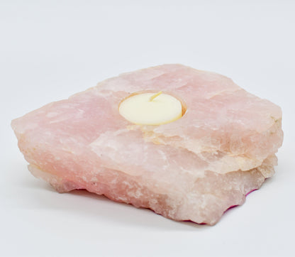  Rose quartz candle holder with a small amount of fat on a white background