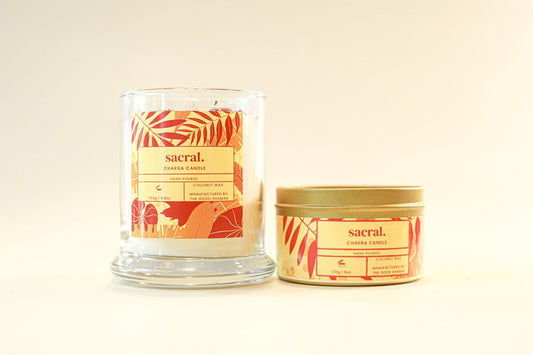 Two candles from the brand 'sacral' on a beige background