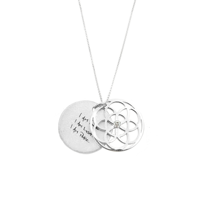 Silver necklace with two interlocking pendants on a white background