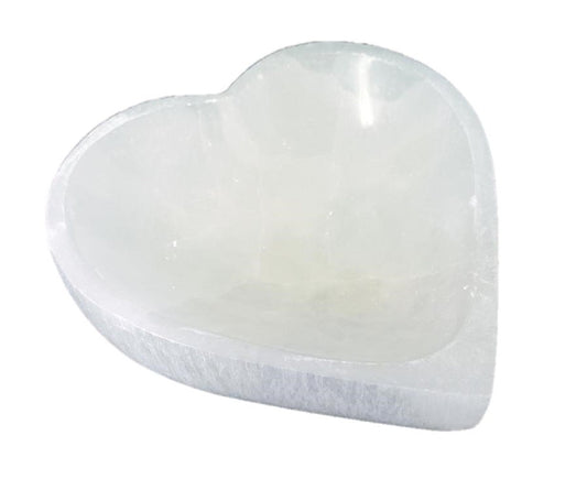 Heart-shaped selenite bowl on a white background